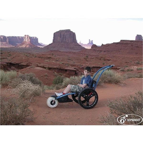 VipaMat Hippocampe Beach All-terrain Wheelchair- with person using product / left side view / desert background
